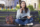 thoughtful-woman-making-notes-sitting-bench-outdoors